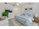 Comfortable bedroom with an area rug, ceiling fan, and cool blue bedding at 3402 Parkridge Cir, Sarasota, FL 34243