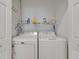 Laundry room features both washer and dryer with storage shelf above at 3402 Parkridge Cir, Sarasota, FL 34243
