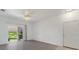 Spacious empty living room showcasing wood floors and access to outdoor seating at 3402 Parkridge Cir, Sarasota, FL 34243