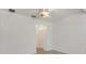 Empty living room with fresh white paint, ceiling fan, and a doorway to the hall at 3402 Parkridge Cir, Sarasota, FL 34243