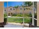 Screened patio with view of landscaped backyard, rock garden, and beige two-story building at 3402 Parkridge Cir, Sarasota, FL 34243