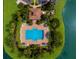 Aerial view of rectangular community pool surrounded by greenery and lounge chairs at 3402 Parkridge Cir, Sarasota, FL 34243