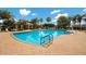 Community pool with ample seating and a clubhouse at 3402 Parkridge Cir, Sarasota, FL 34243