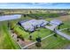 Stunning aerial view of a sprawling estate with a white fence, a private lake, screened pool, and lush landscaping at 3574 Recurve Cir, Sarasota, FL 34240