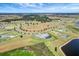 Overhead view of the beautiful home, landscaped yard, and neighborhood ponds against a picturesque landscape at 3574 Recurve Cir, Sarasota, FL 34240