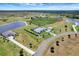 Vast aerial view of the property, highlighting the pond, outbuildings, mature trees and the home's beautiful surroundings at 3574 Recurve Cir, Sarasota, FL 34240