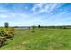 Expansive green backyard with a pond and trees at 3574 Recurve Cir, Sarasota, FL 34240
