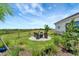 Well-maintained backyard with a seating area and lush landscaping at 3574 Recurve Cir, Sarasota, FL 34240
