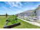 Backyard featuring garden, white fence, and green grass at 3574 Recurve Cir, Sarasota, FL 34240