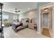 Bright bedroom with ceiling fan, desk and egg chair; connects to hallway at 3574 Recurve Cir, Sarasota, FL 34240