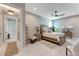 Bedroom featuring neutral decor, a ceiling fan, and a large window for natural light at 3574 Recurve Cir, Sarasota, FL 34240