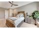 This bedroom has a neutral color palette, a ceiling fan, and a plant to add a touch of greenery at 3574 Recurve Cir, Sarasota, FL 34240