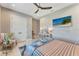 Inviting bedroom with beach art, modern fan, and ample closet space; with natural lighting at 3574 Recurve Cir, Sarasota, FL 34240