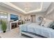 Bright bedroom with decorative mirrors, a modern television, and a bright decor at 3574 Recurve Cir, Sarasota, FL 34240