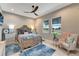 Comfortable bedroom with stylish accents, a modern fan, two windows, and ample natural light at 3574 Recurve Cir, Sarasota, FL 34240