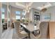 Elegant dining room featuring a rustic table, high ceilings, and designer lighting at 3574 Recurve Cir, Sarasota, FL 34240
