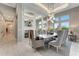 Bright dining room with large windows and statement lighting fixture at 3574 Recurve Cir, Sarasota, FL 34240