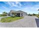 Beautiful single-story home featuring a three-car garage, charming front porch, and paved driveway at 3574 Recurve Cir, Sarasota, FL 34240
