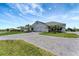 Spacious single-story home featuring an attached three-car garage and a large paved driveway at 3574 Recurve Cir, Sarasota, FL 34240