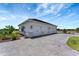 Exterior featuring four car garage and paved driveway at 3574 Recurve Cir, Sarasota, FL 34240