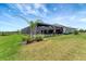 Expansive backyard with a screened-in lanai and lush landscaping, offering privacy and outdoor enjoyment at 3574 Recurve Cir, Sarasota, FL 34240