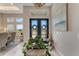 Inviting foyer featuring a modern chandelier, double glass doors, and views of the dining room at 3574 Recurve Cir, Sarasota, FL 34240