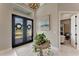 Bright foyer with modern decor, featuring double doors and a glimpse into an office at 3574 Recurve Cir, Sarasota, FL 34240