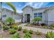 Elegant front entrance with stone walkway, glass front doors, and lush landscaping at 3574 Recurve Cir, Sarasota, FL 34240