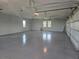 Spacious and clean garage featuring painted floors, high ceilings, and plenty of room for vehicles and storage at 3574 Recurve Cir, Sarasota, FL 34240