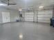 Spacious three-car garage with epoxy flooring and three garage door openers at 3574 Recurve Cir, Sarasota, FL 34240