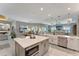 Bright kitchen with an island, stainless steel appliances, and an open floor plan to living room and dining area at 3574 Recurve Cir, Sarasota, FL 34240
