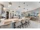 Bright kitchen with an expansive island, bar seating, and an open layout connecting to the dining and living areas at 3574 Recurve Cir, Sarasota, FL 34240
