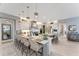 Spacious kitchen featuring an oversized island with seating, modern appliances, and stylish pendant lighting at 3574 Recurve Cir, Sarasota, FL 34240