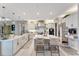 Bright, modern kitchen featuring white cabinets, a central island with seating, and stainless steel appliances at 3574 Recurve Cir, Sarasota, FL 34240