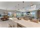Bright kitchen with an island sink, dining area and living room access in an open floor plan, and modern style at 3574 Recurve Cir, Sarasota, FL 34240