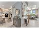 Open-concept kitchen with a view to the dining area, featuring a large island with bar stool seating and modern appliances at 3574 Recurve Cir, Sarasota, FL 34240