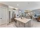 Spacious kitchen showcasing a center island with seating, stainless steel appliances, and seamless flow into other living spaces at 3574 Recurve Cir, Sarasota, FL 34240