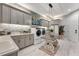 Bright laundry room includes ample cabinet space, modern appliances, and a decorative table at 3574 Recurve Cir, Sarasota, FL 34240
