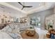 A modern living room featuring a ceiling fan, sliding glass doors, and view of kitchen and dining area at 3574 Recurve Cir, Sarasota, FL 34240