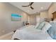 Bright main bedroom with coastal decor, modern ceiling fan, and an ensuite bathroom at 3574 Recurve Cir, Sarasota, FL 34240