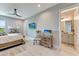 Bright main bedroom features coastal decor, wood dresser, and modern ceiling fan and has an ensuite bathroom at 3574 Recurve Cir, Sarasota, FL 34240