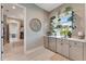 Bright pantry with open shelving, ample counter space, and stainless steel refrigerator at 3574 Recurve Cir, Sarasota, FL 34240