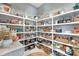 A well stocked walk in pantry with white shelving and a variety of pantry goods and storage baskets at 3574 Recurve Cir, Sarasota, FL 34240