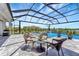 Stunning screened-in pool area features a spa, waterfall, and comfortable seating area at 3574 Recurve Cir, Sarasota, FL 34240