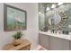Stylish powder room features decorative mirror, modern vanity, and light green subway tile at 3574 Recurve Cir, Sarasota, FL 34240