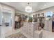 Large walk-in closet with custom shelving, storage, and a center island at 3574 Recurve Cir, Sarasota, FL 34240