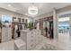 Spacious walk-in closet with custom storage solutions and central island at 3574 Recurve Cir, Sarasota, FL 34240