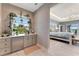 Charming wet bar featuring sleek countertops and custom shelving adjacent to main bedroom at 3574 Recurve Cir, Sarasota, FL 34240