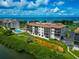 Coastal condo complex with pool, mature landscaping, and panoramic ocean views near a beautiful sandy beach at 3630 Gulf Of Mexico Dr # 202, Longboat Key, FL 34228