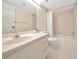 Bathroom with tile floors, tile walls, a vanity and a tub with a shower at 3630 Gulf Of Mexico Dr # 202, Longboat Key, FL 34228